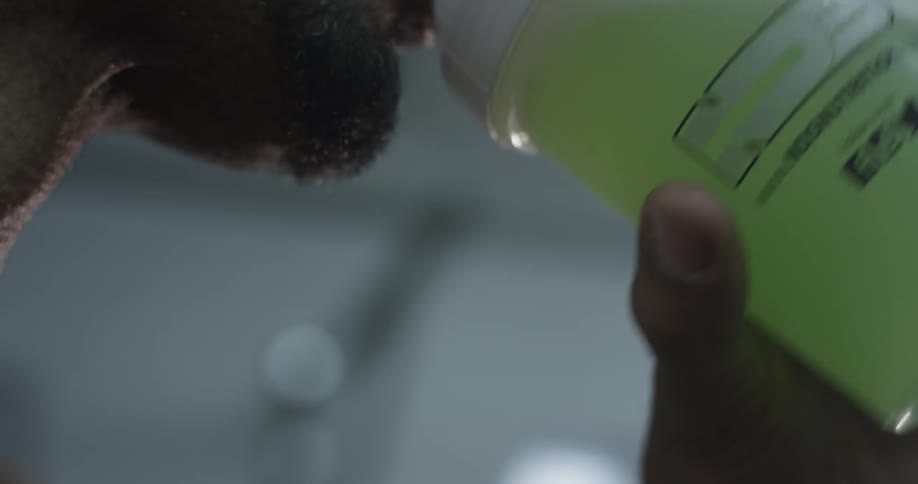 A man that is drinking a protein shake at a gym