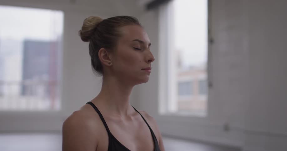 A woman meditates with her eyes closed