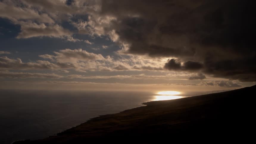 Sunrise on lake with dark clouds