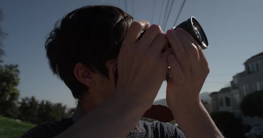 Man takes a picture of the city on a sunny day