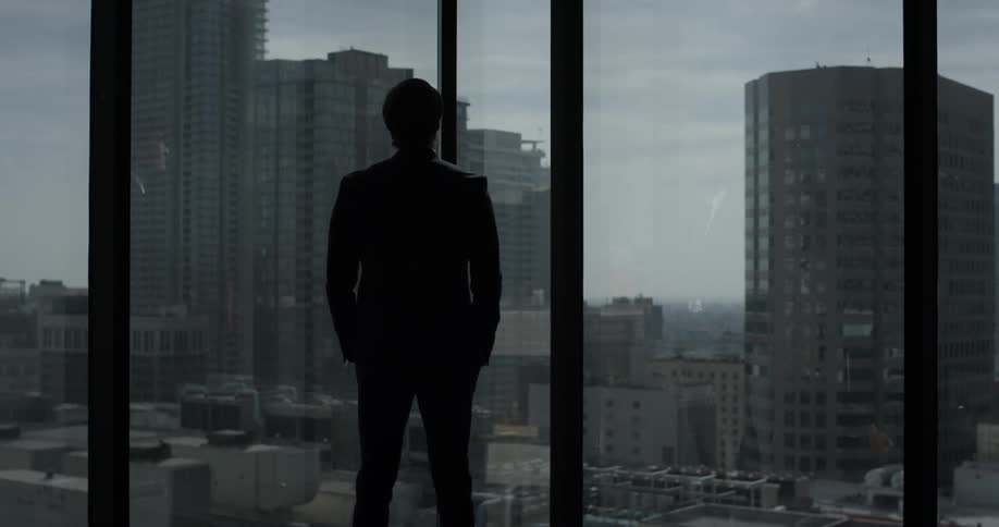 A man is staring out the window