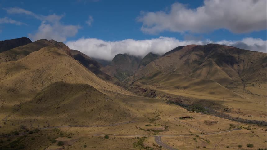 Grassy hills with partly cloudy sky