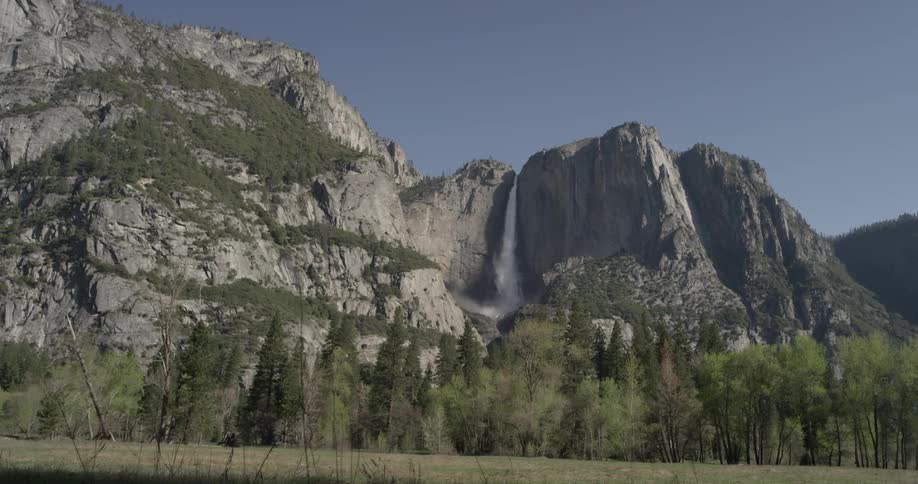 A waterfall cascades down a mountain side