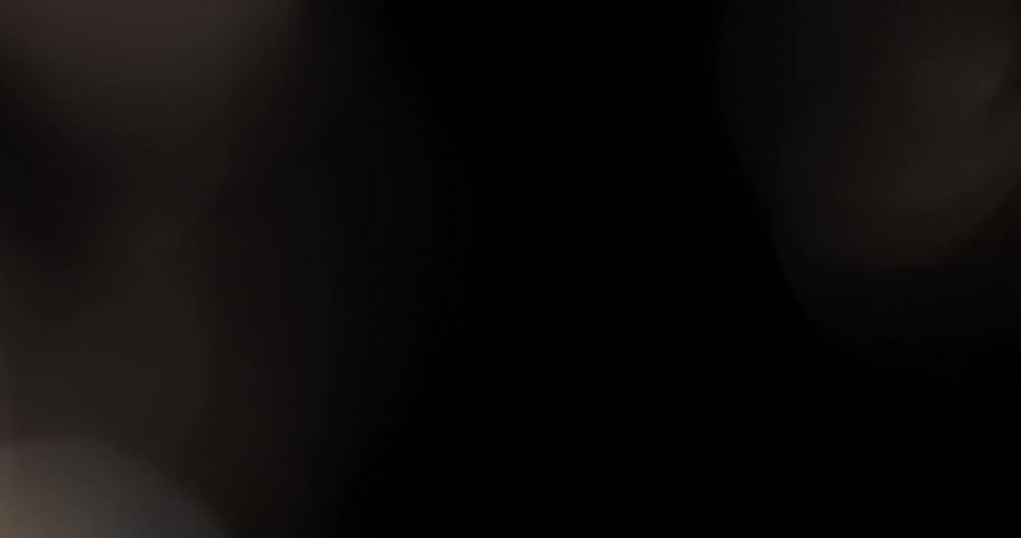 Light is shifting around with heptagonal blurry shapes appearing against a black background in this abstract video