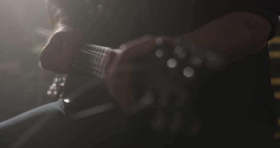 Man tests tension on guitar strings