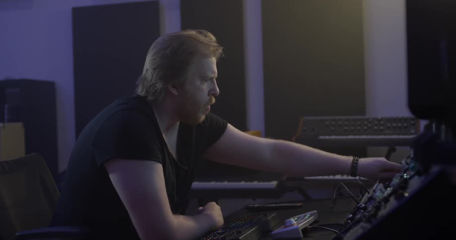 A man mixing audio in a studio