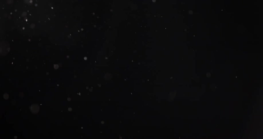 Snow falls in the dark