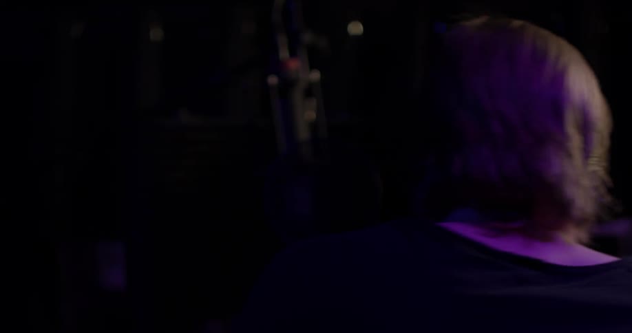 A man taking off headphones in a studio