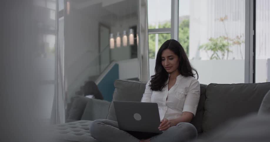 Woman In Apartment Using Electronics
