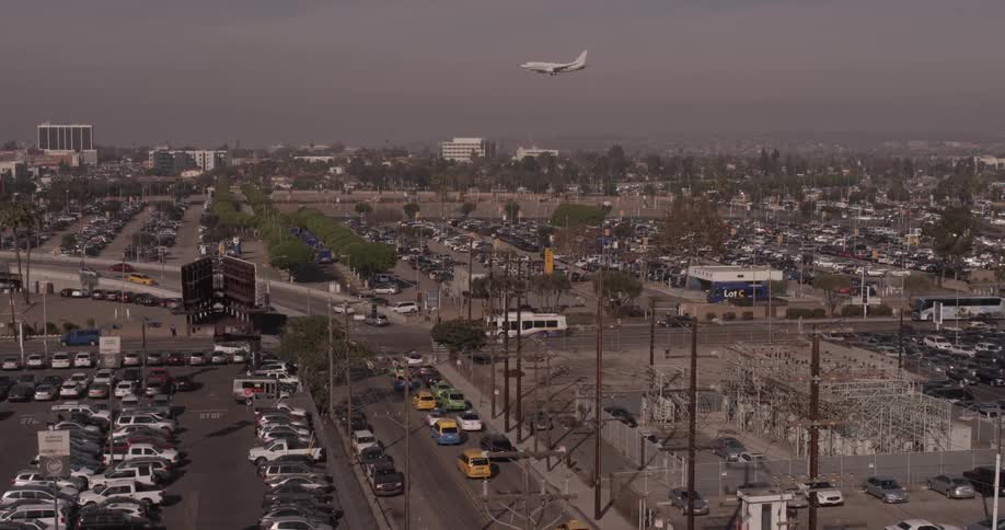 City streets at dawn, with airplane flying in the background