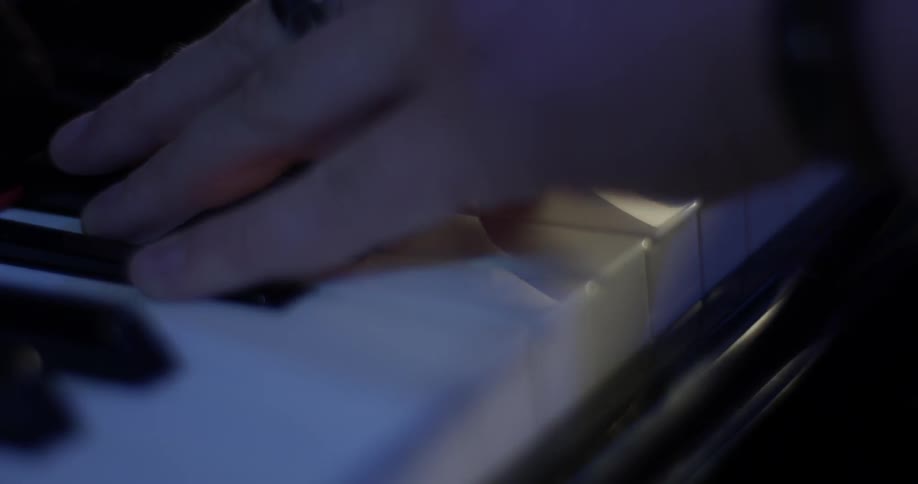 A man playing a piano in a studio