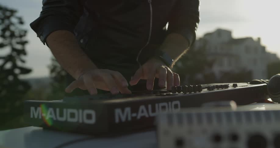 A man plays a keyboard on a rooftop