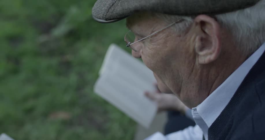 Man reading aloud in a park