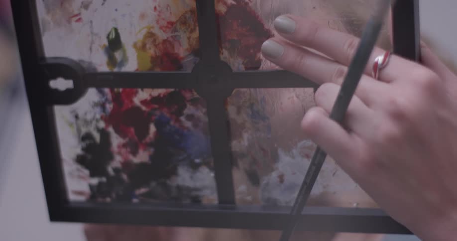 A person that is holding a painting palette in their hands