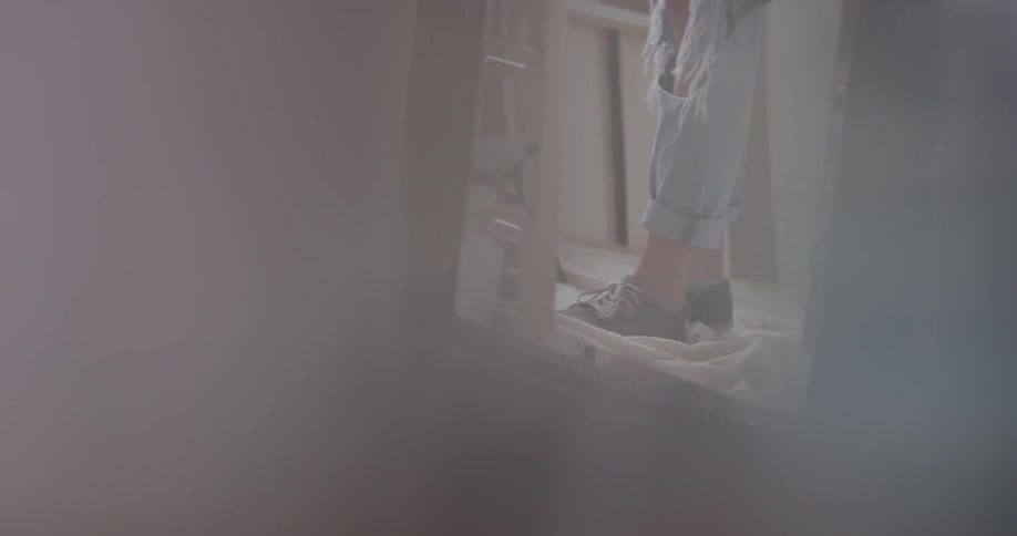 A person's reflection is shown on a mirror