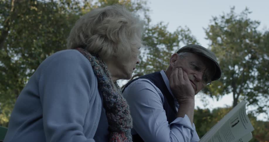 A man and women are talking outdoors
