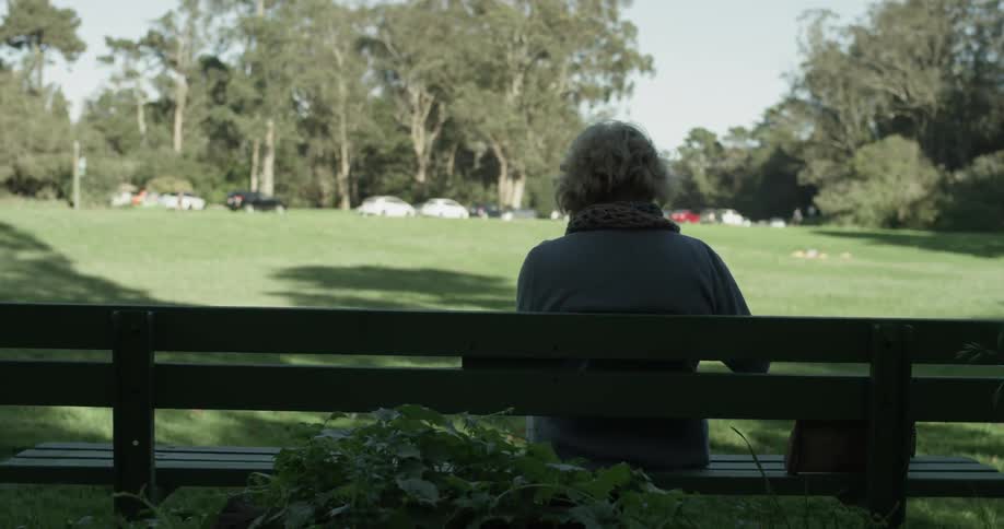 A person sitting on a bench outside