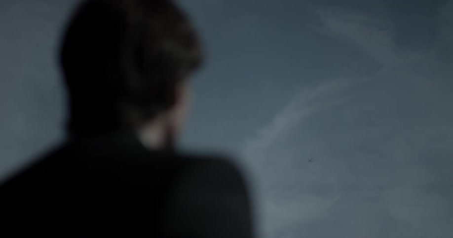 A man is looking outside