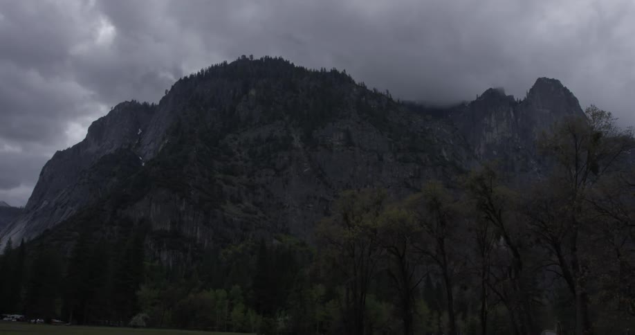 Dark clouds frame tall mountains