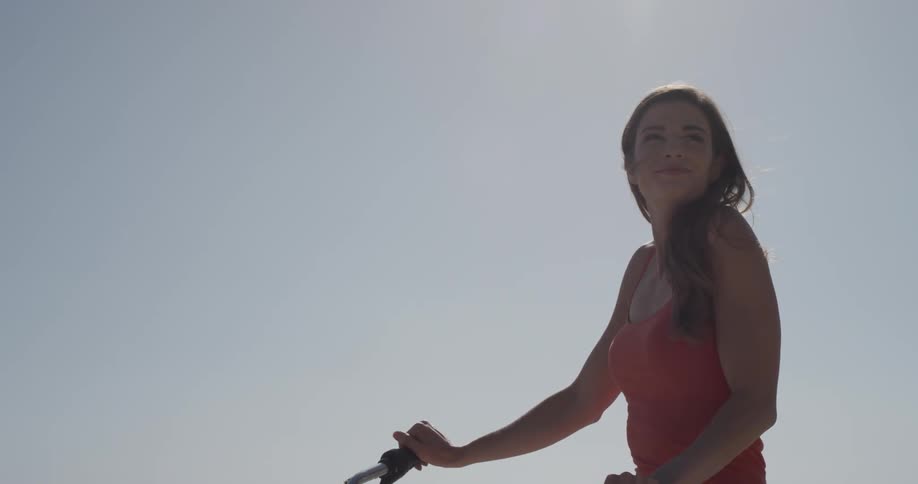 Woman rides a bike past several other people