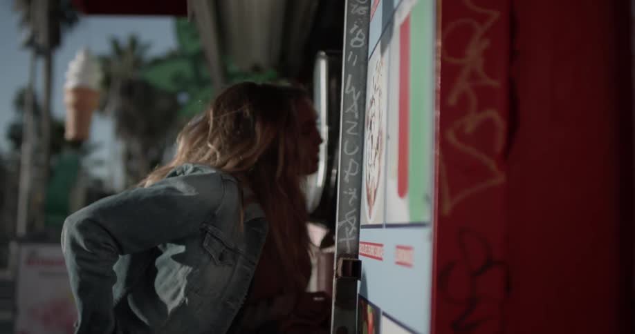 Two women walk up to a store front