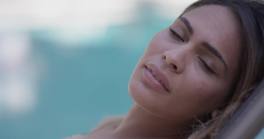 A woman is staring while laying down