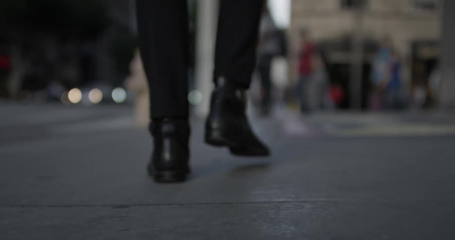 A man walks down the sidewalk in the inner city