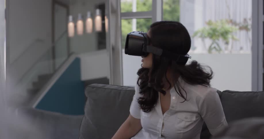 A woman is scared while using a virtual reality visor