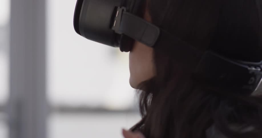 Woman reacting to what she sees in her virtual reality glasses