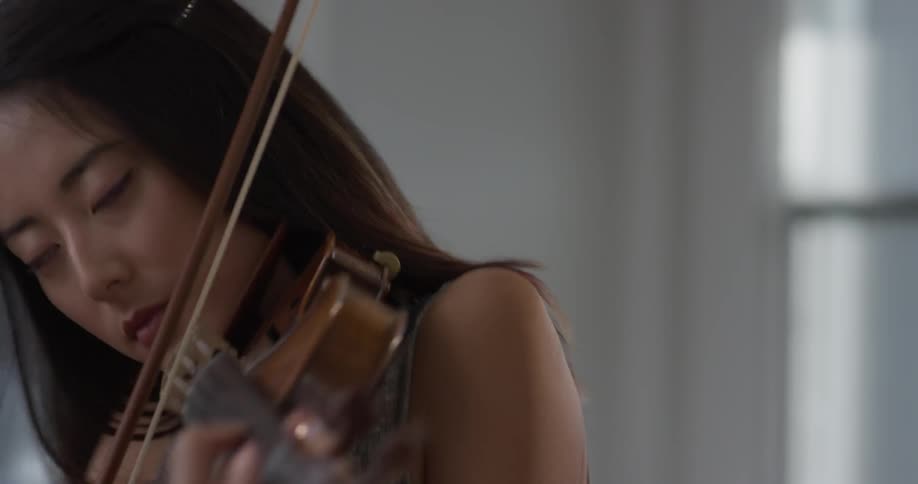 Woman plays the violin swaying back and forth