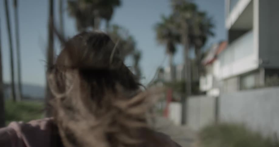 A woman twirls in the sun