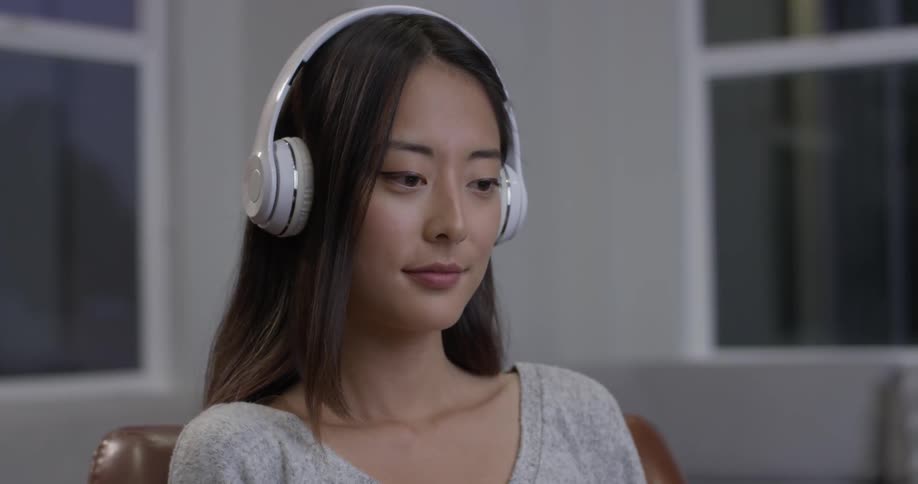Woman putting on a pair of headphones