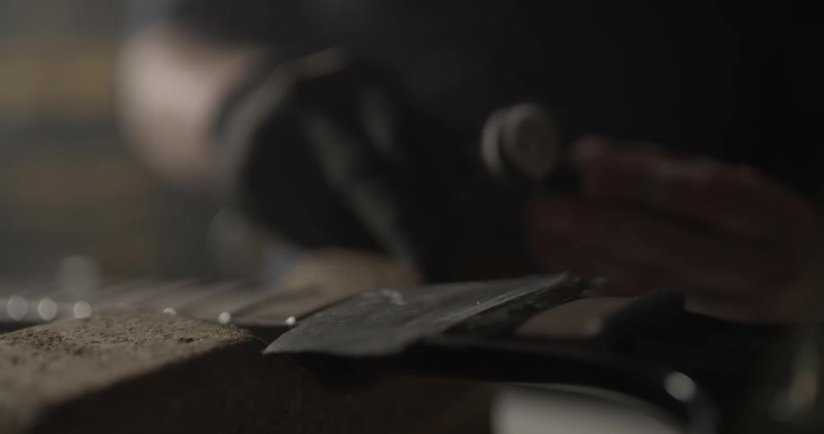 Man Making Guitar In Workshop