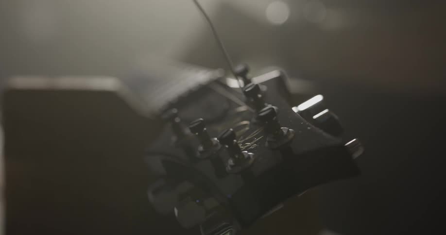 Person strings guitar