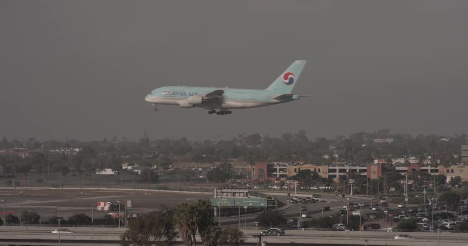 A plane flying over a highway