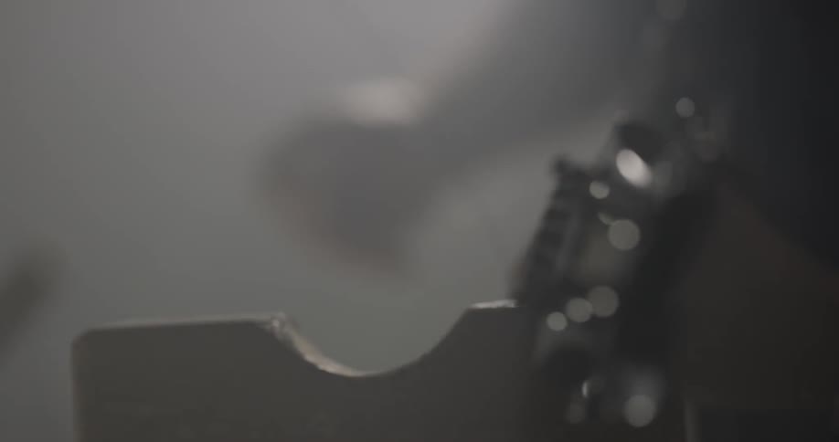 A man adjusts the strings on a guitar