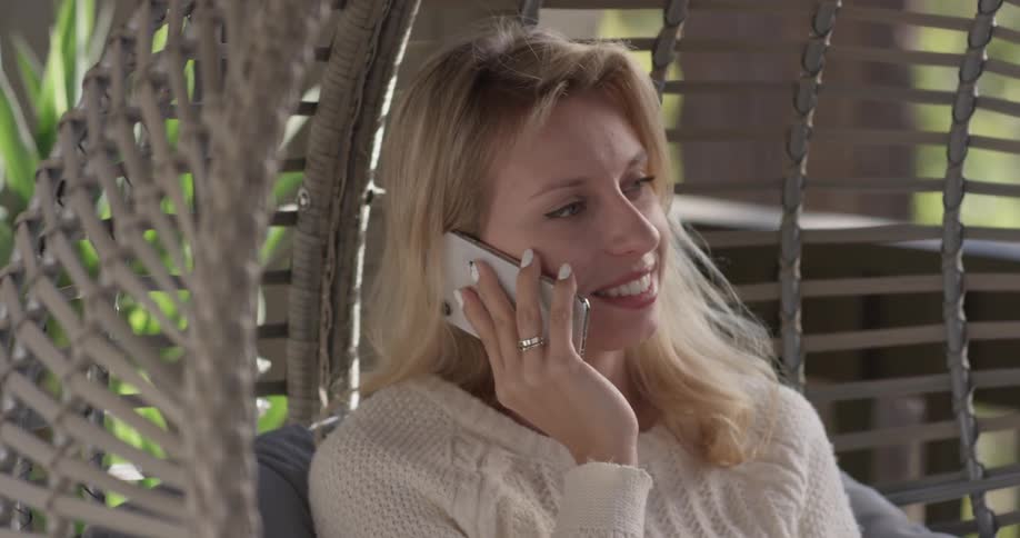 Woman talking on a phone outdoors