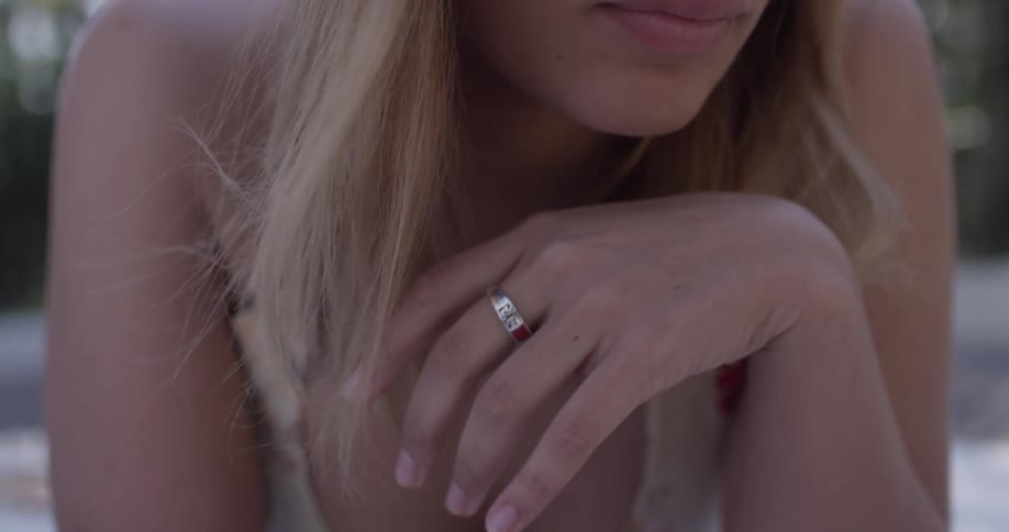 A woman wearing a ring while laying down