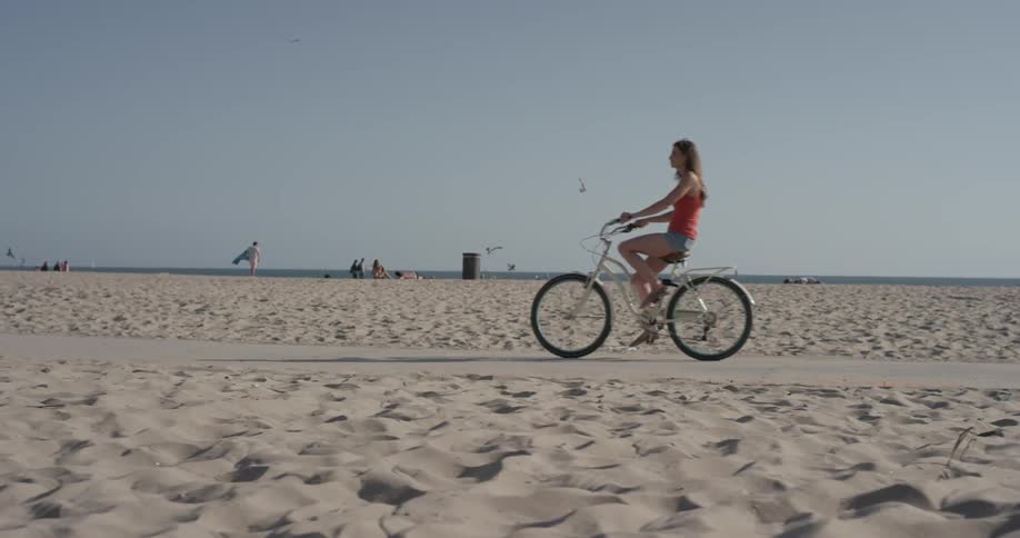 A woman is riding a bicycle outside