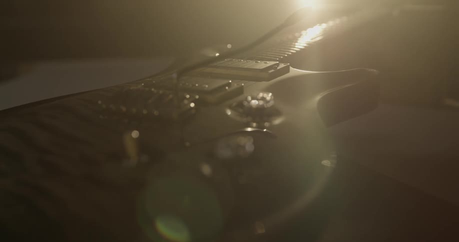 A guitar sits in the sunlight