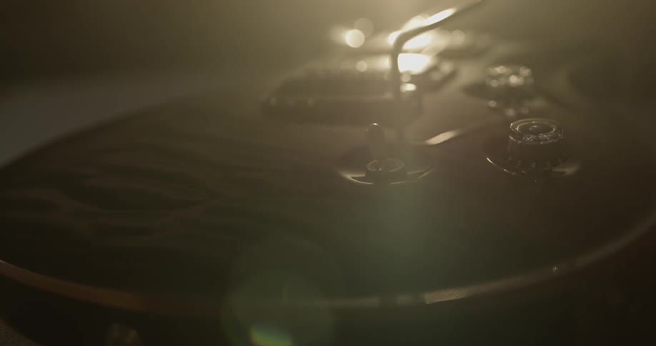 Light shines across the dials and body of an electric guitar