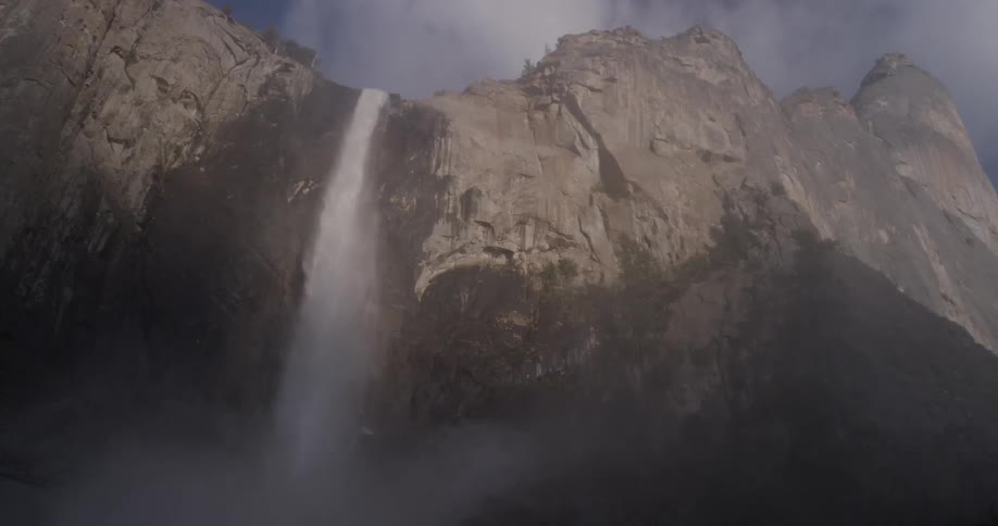 A waterfall is going down the mountain