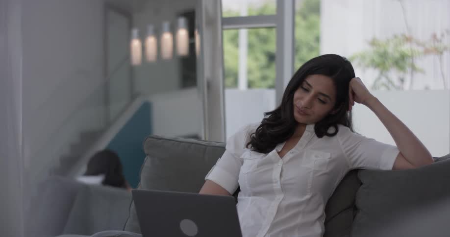 Woman In Apartment Using Electronics