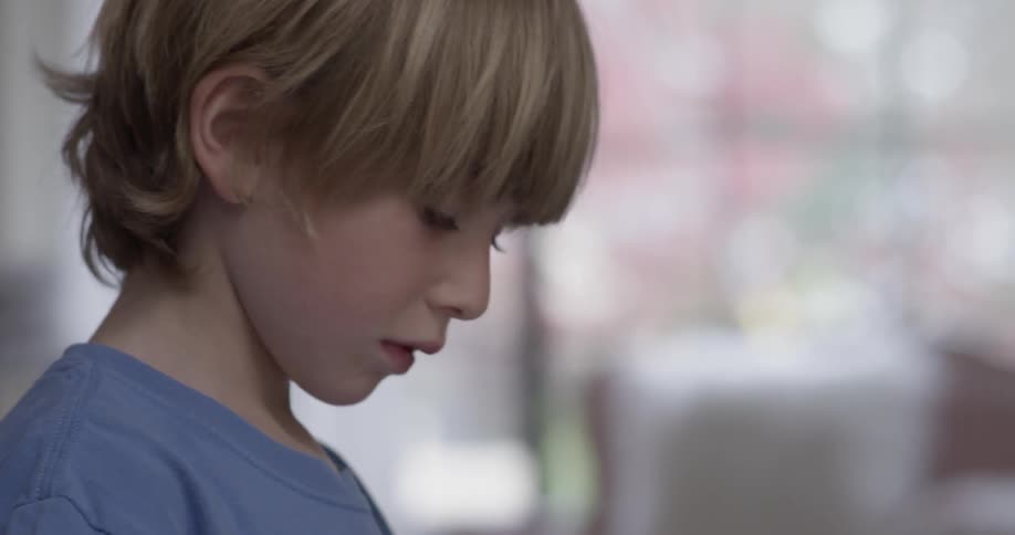 A boy looks to the side