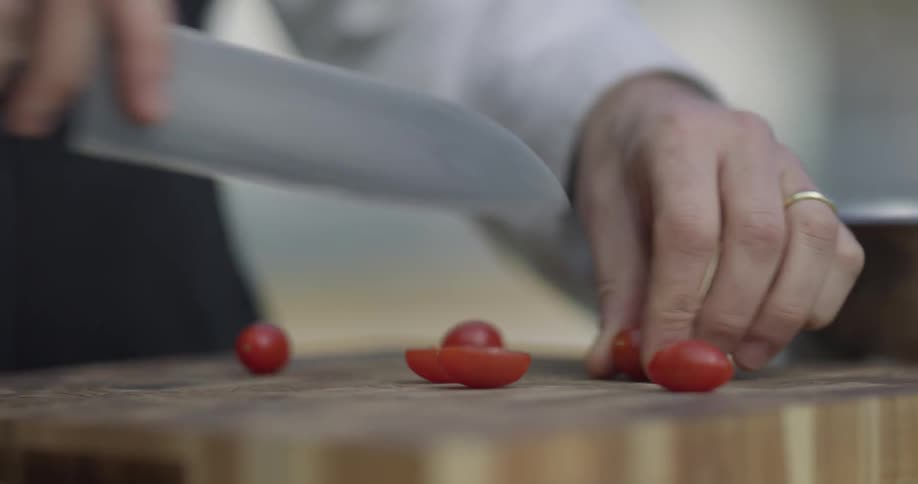A woman is cutting tomatoes