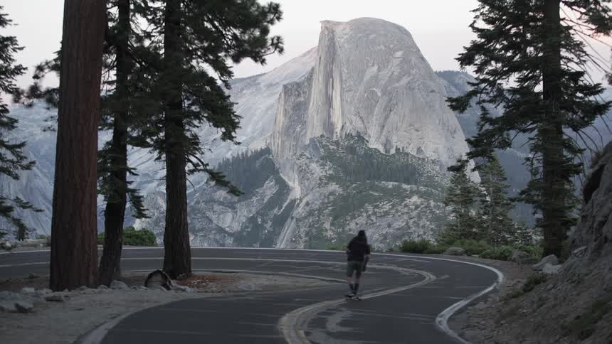 A man is skating through a mountain range