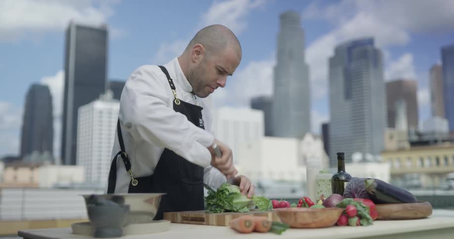 Man chops lettuce in kitchen