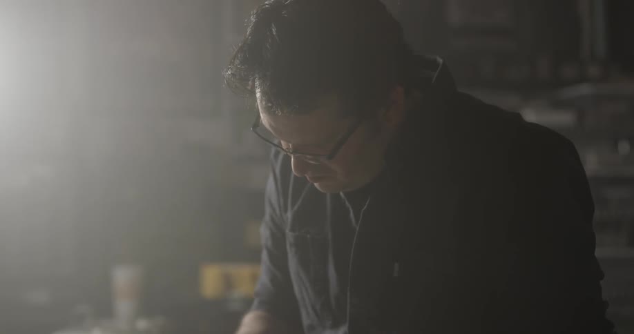 Man Making Guitar In Workshop