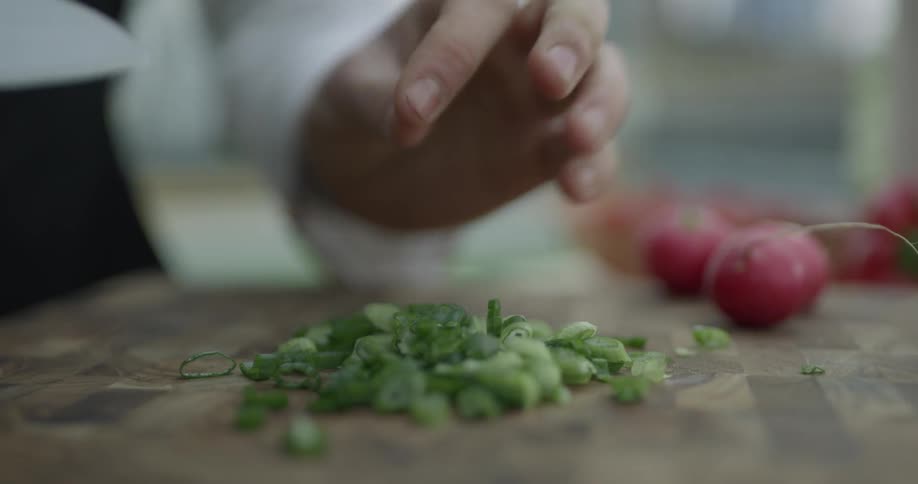 A person is cutting vegetables with a knife