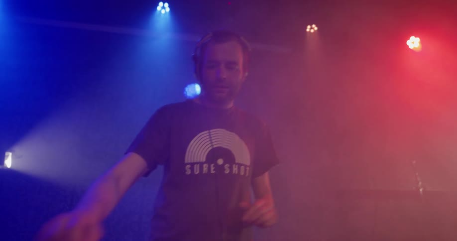 A man is playing music at a venue